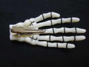 Pince clip à cheveux main de squelette os phosphorescent